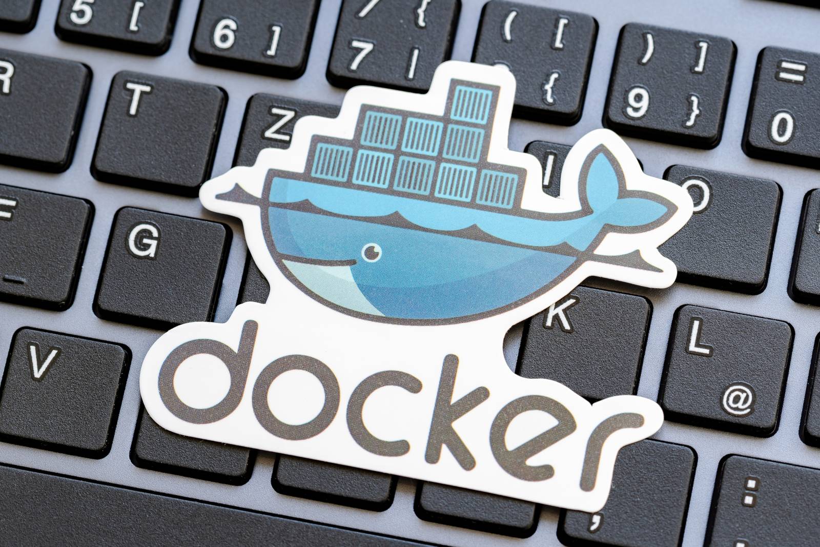 Docker whale logo on a blue background illustrating containerized application shipping